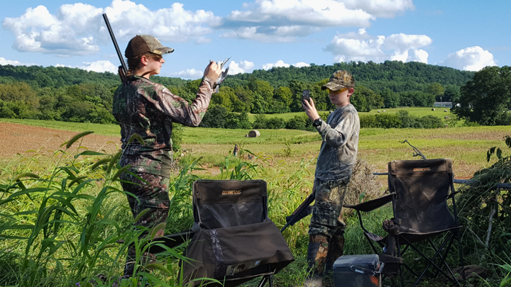 Older hunter and younger hunter in the field