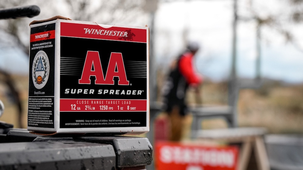 Winchester AA Super Spreader ammunition box sitting on a table at a shooting range