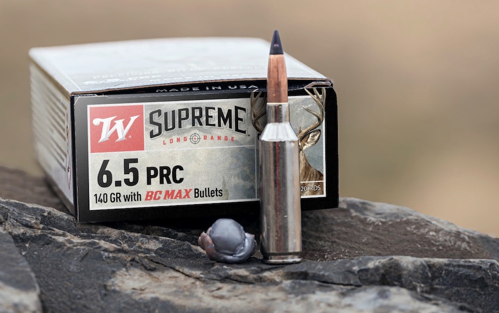Box of Supreme Long Range 6.5 PRC ammunition with an unfired round and deformed bullet in front.