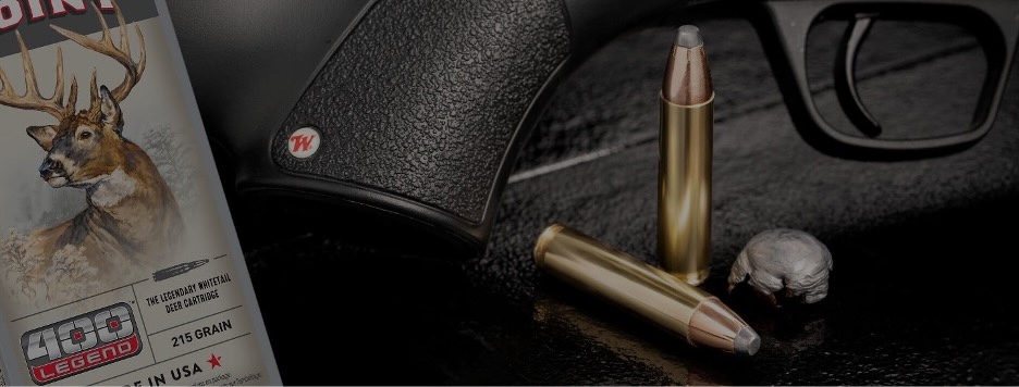 Deer Season XP 400 Legend ammunition box and bullets lying on a table next to a rifle.