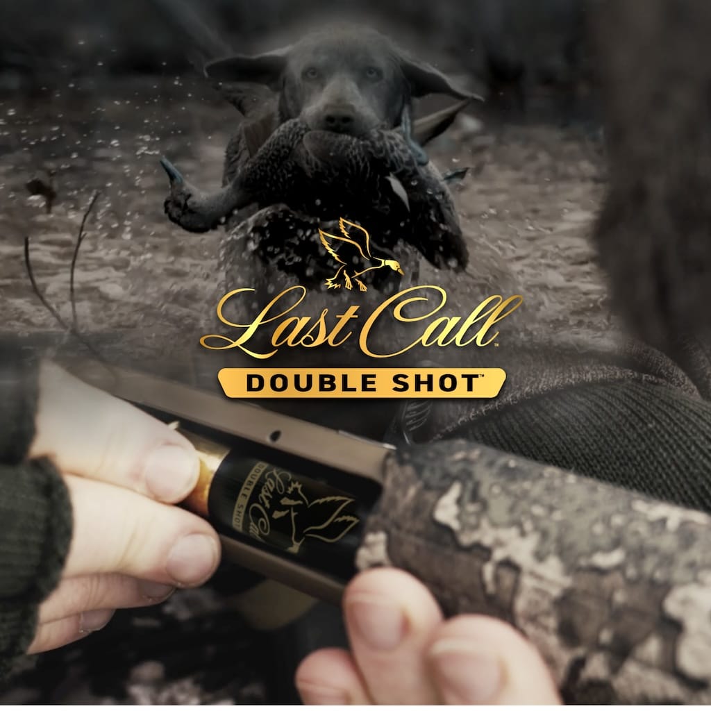 Last Call Double Shot shell being loaded into a shotgun and a dog running through shallow water with a duck in its mouth