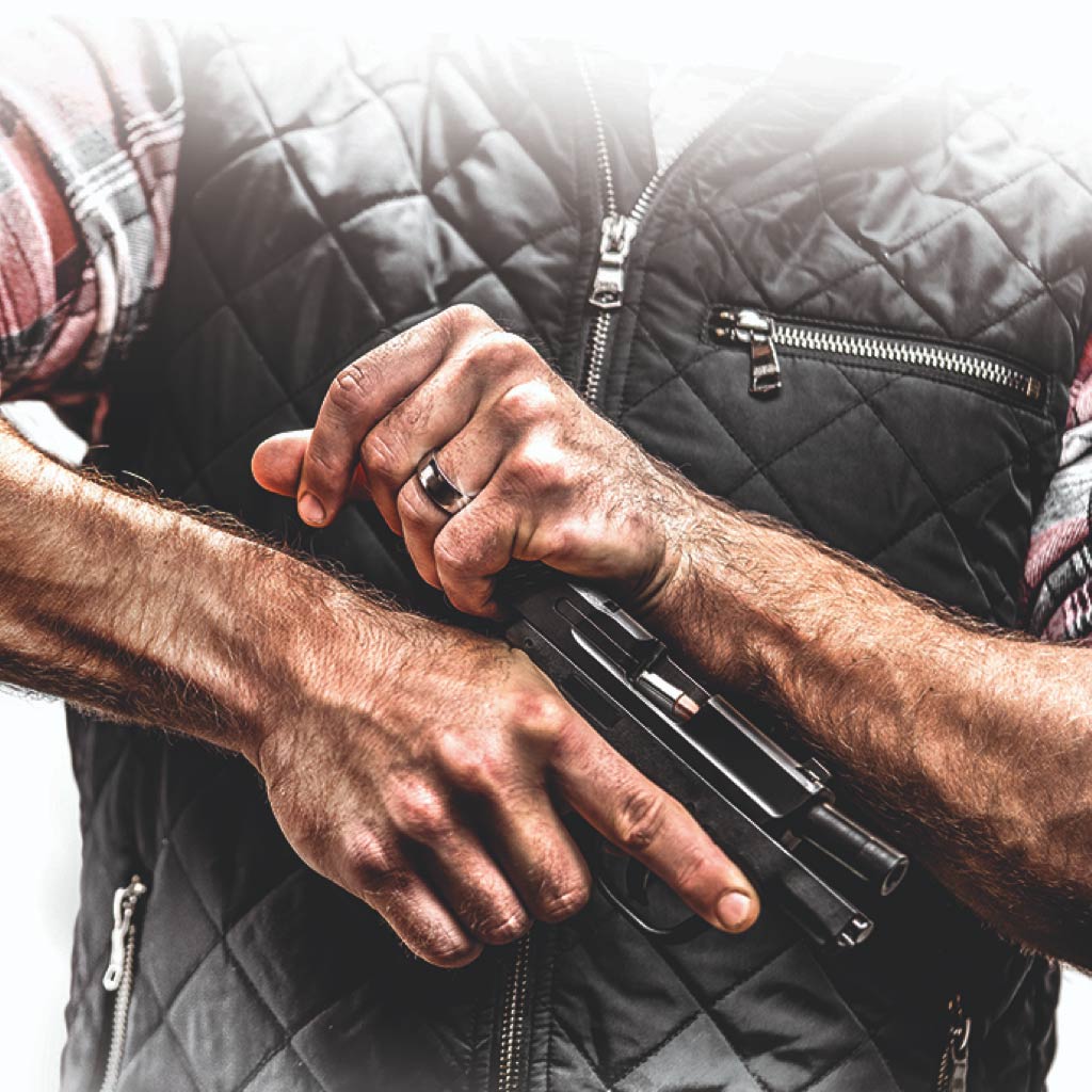 Man holding gun showing chamber open