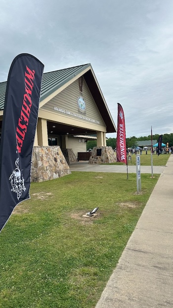 View of one of the main facility buildings and Winchester banners at the Mack’s Prairie Wings Youth Shooting Sports Trap Shoot & Shot Curtain Exhibit event
