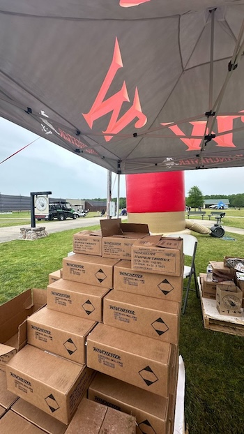 Stack of Winchester product boxes at the team tent at the Mack’s Prairie Wings Youth Shooting Sports Trap Shoot & Shot Curtain Exhibit event