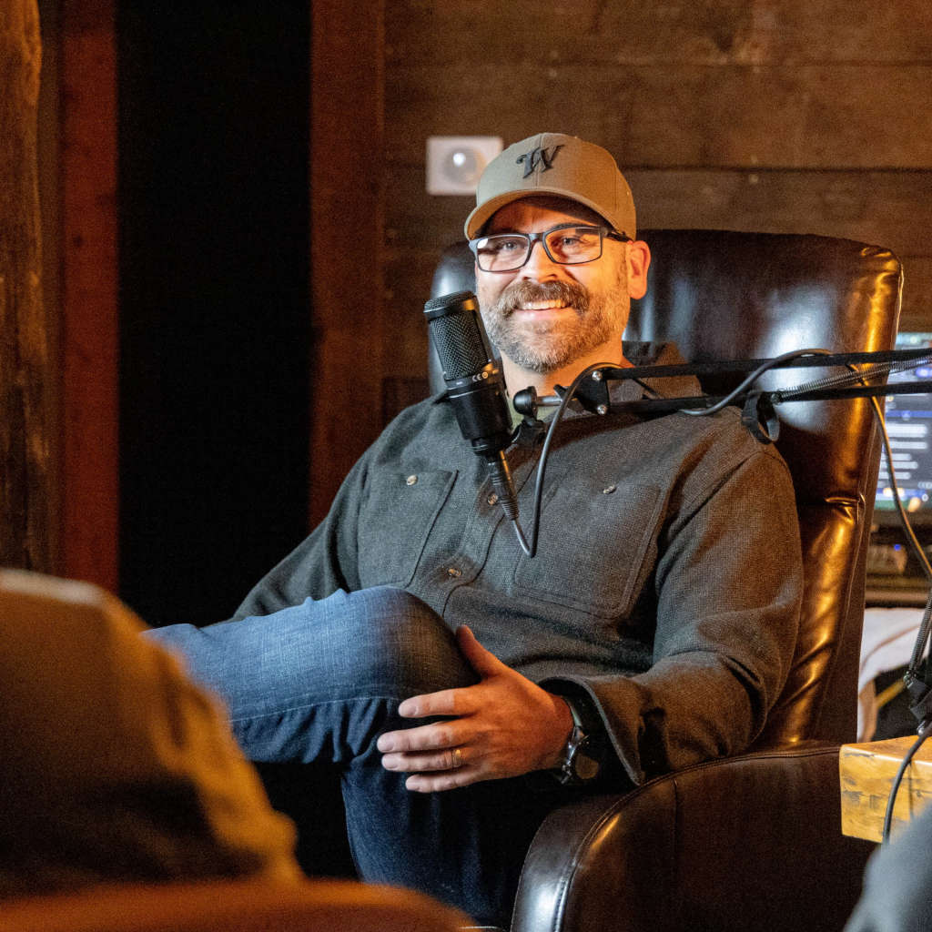 Winchester Life Podcast host seated at a table with a large boom microphone